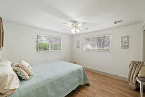 Bedroom with a ceiling fan, recessed lighting, gorgeous views, natural light and built in desk