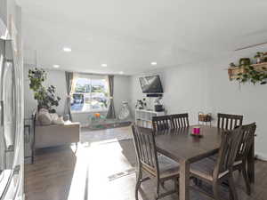 Dining area with wood finished floors and recessed lighting