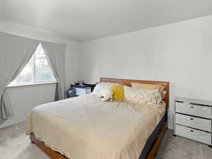 Carpeted bedroom featuring baseboards