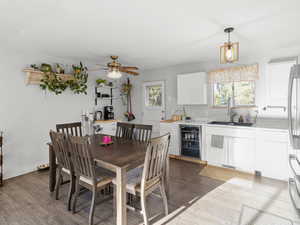 Dining room with beverage cooler, healthy amount of natural light, and wood finished floors