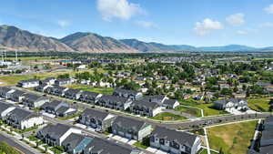Aerial view of property's location featuring a mountainous background and nearby suburban area