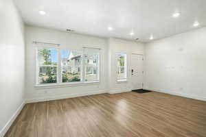 Entrance foyer featuring plenty of natural light, wood finished floors, and recessed lighting