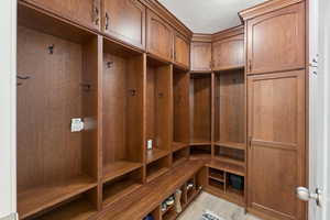 Mudroom with light wood-style floors, a textured ceiling, and a sauna