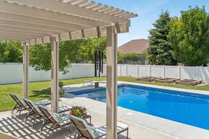 View of pool with a pergola, a fenced backyard, and a patio area