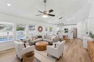 Living area featuring a ceiling fan, light wood-style floors, recessed lighting, and high vaulted ceiling