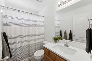 Full bath featuring vanity and a shower with curtain