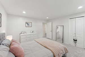 Bedroom featuring light carpet, a closet, and recessed lighting