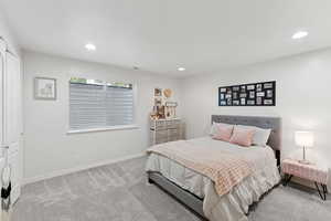 Carpeted bedroom featuring recessed lighting and baseboards