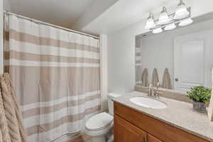 Full bath with vanity and a shower with curtain