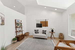 Sitting room featuring light wood-style flooring, recessed lighting, and a skylight