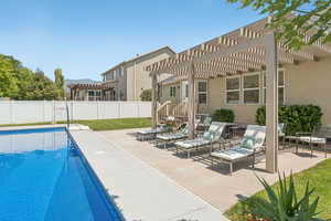 View of pool with a pergola, a fenced backyard, a patio area, and a mountain view
