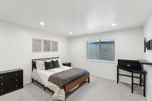 Carpeted bedroom with baseboards and recessed lighting