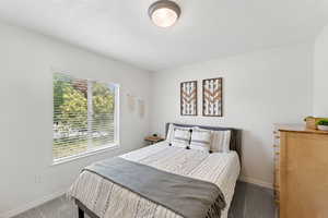 Bedroom featuring carpet floors and baseboards