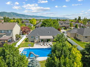 View of pool featuring a residential view, a fenced backyard, a pergola, and a mountain view