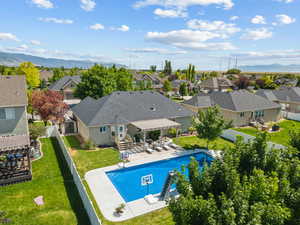 View of swimming pool with a residential view, a fenced backyard, a patio area, a mountain view, and a pergola