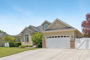 View of front of house featuring stucco siding, concrete driveway, a garage, and a gate