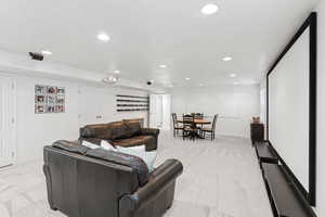 Living room with light colored carpet and recessed lighting