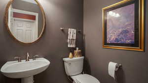 Half bathroom featuring a sink and toilet