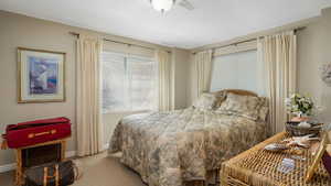 Bedroom featuring carpet and baseboards
