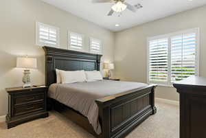 Bedroom featuring light carpet, multiple windows, ceiling fan, and recessed lighting