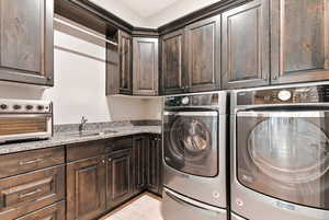Laundry area with independent washer and dryer and a sink