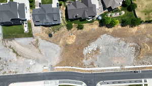 Aerial view of property and surrounding area with nearby suburban area