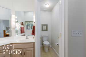 Ensuite bathroom featuring tile patterned floors and vanity