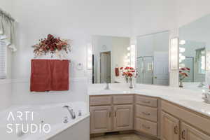 Full bathroom featuring double vanity, a stall shower, a tub with jets, and tile patterned floors