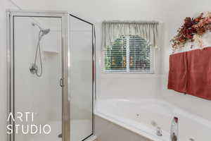 Full bathroom with a stall shower and a tub with jets