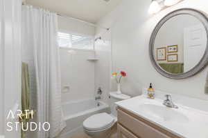 Full bathroom featuring shower / tub combo and vanity