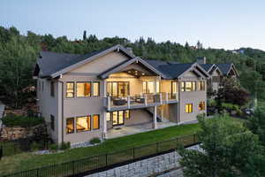 Back of house featuring a fenced backyard, stucco siding, and a patio