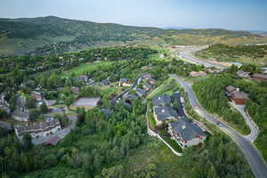 Aerial view of property's location featuring nearby suburban area and a mountain backdrop