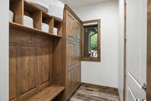Mudroom featuring wood finished floors and baseboards