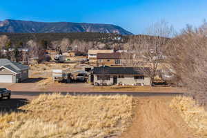 View of mountain backdrop featuring nearby suburban area