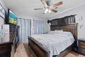 Bedroom with wood finished floors and a ceiling fan