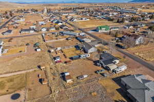 Aerial view of property and surrounding area featuring a mountainous background