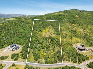 Aerial overview of property's location featuring property parcel outlined and mountains