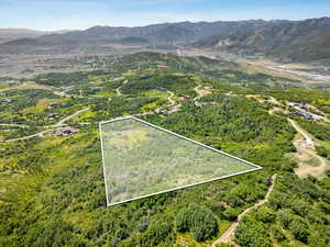 Aerial overview of property's location featuring mountains and property parcel outlined