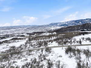 Snowy aerial view featuring a mountain view