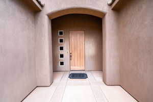View of exterior entry with stucco siding