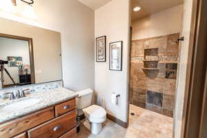 Full bath featuring vanity and a tile shower
