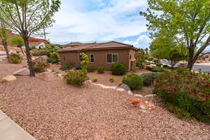 View of side of property featuring stucco siding and a tile roof