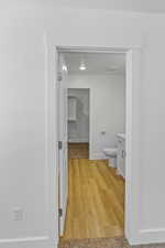 Hallway with light wood-type flooring