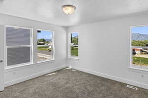 Carpeted empty room featuring baseboards