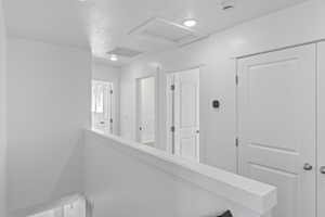 Hall featuring attic access