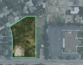 Aerial view of corner lot beside a church meetinghouse