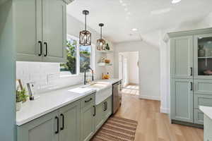 Kitchen with dishwasher, tasteful backsplash, green cabinetry, light wood-style flooring, and recessed lighting