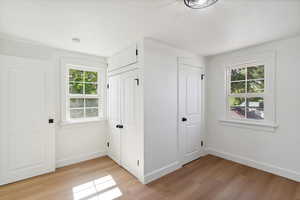 Unfurnished bedroom with light wood finished floors