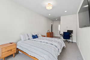 Bedroom with carpet, attic access, and recessed lighting