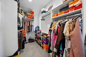 Spacious closet with carpet flooring